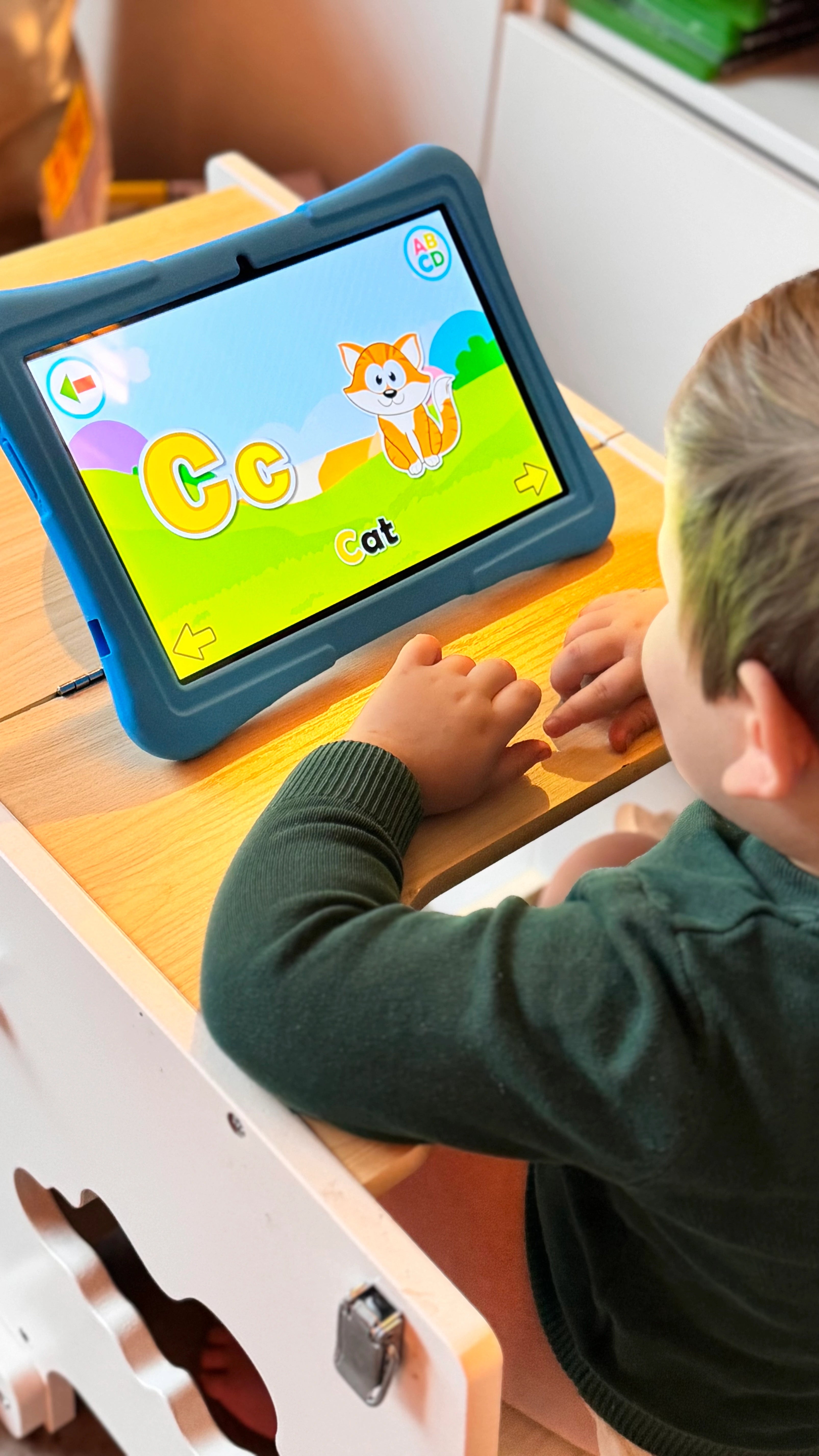 Jongetje speelt een leerzaam spel op een blauwe Kindertablet Pro